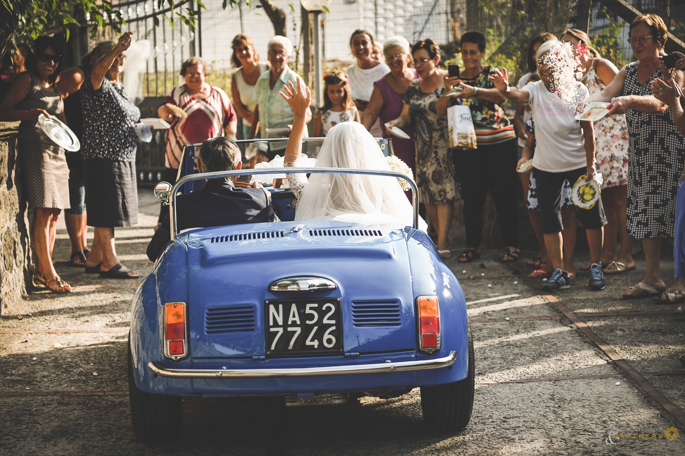 The neighbors greet the bride who goes to church.